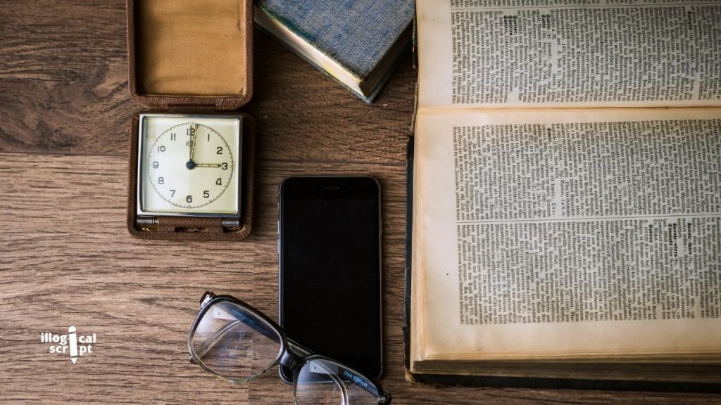 Books with phone, glasses, and a watch