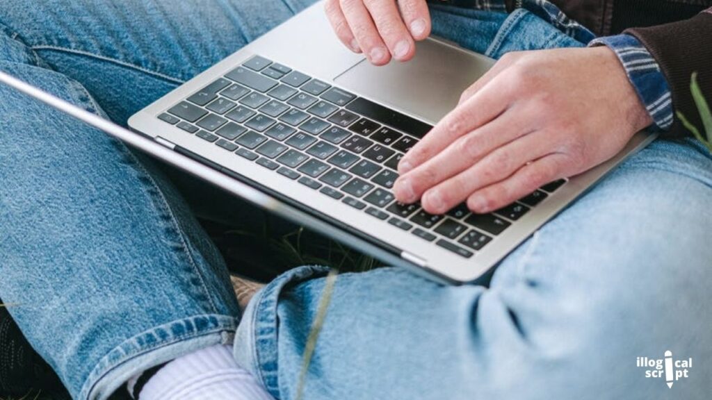 a man typing on a laptop