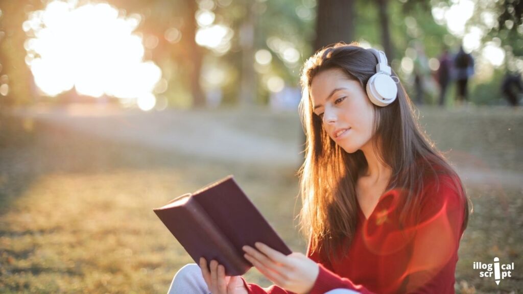 a girl reading a book with headphones on