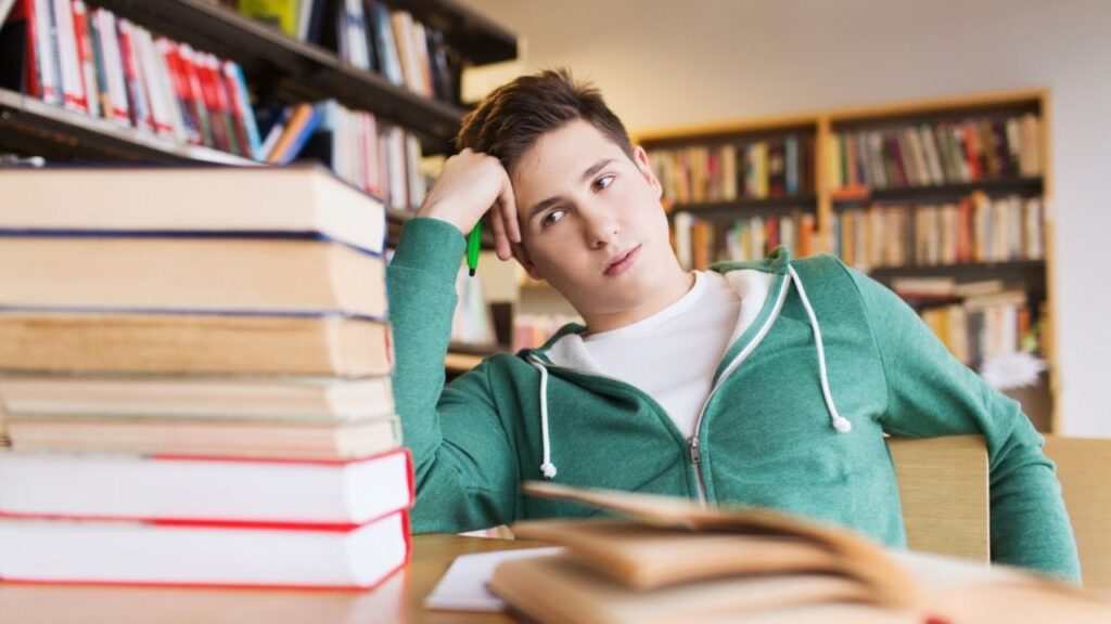 a man looking at books frustrated