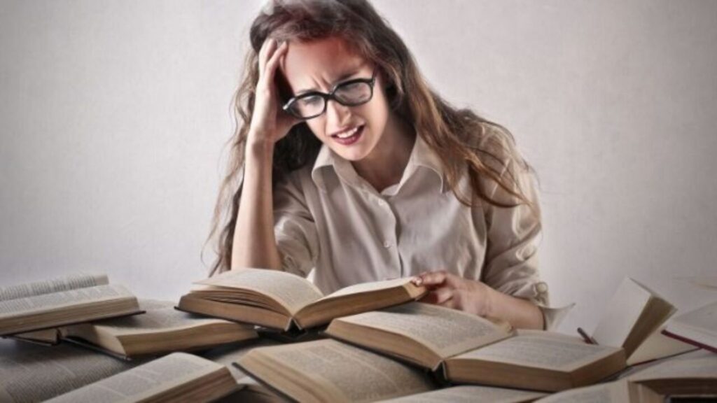 woman getting irritated because of books