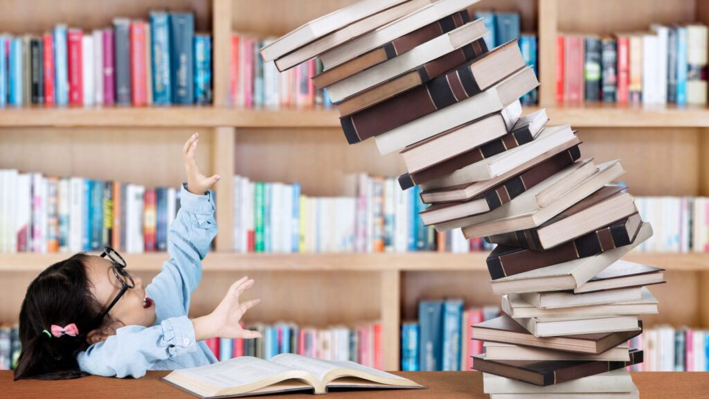 pile of books falling on a young girl