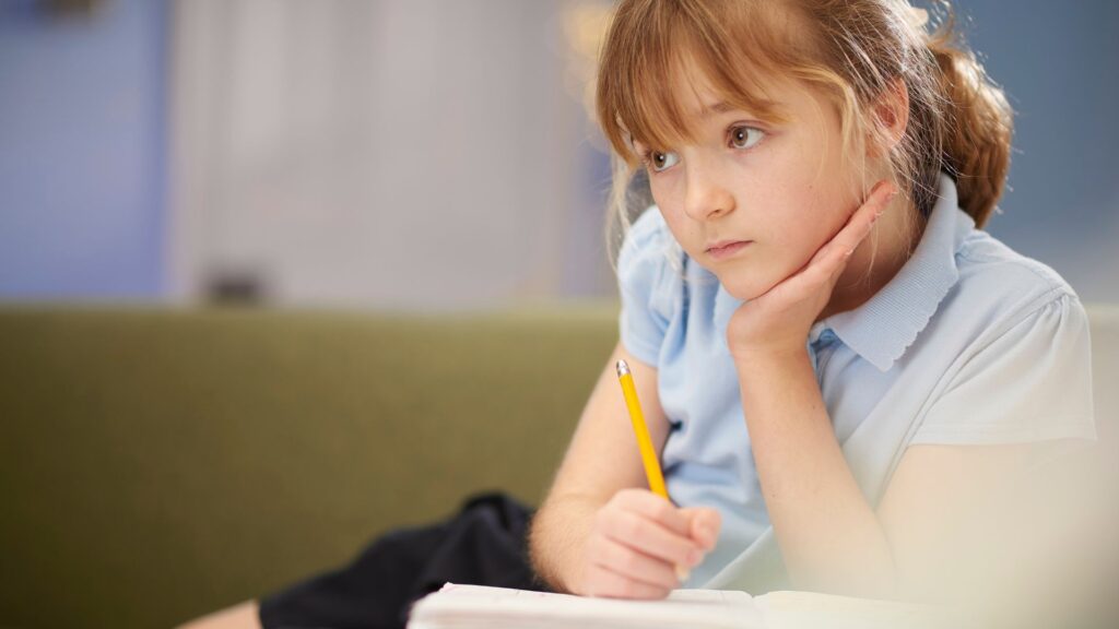 A girl thinking with pencil in hand