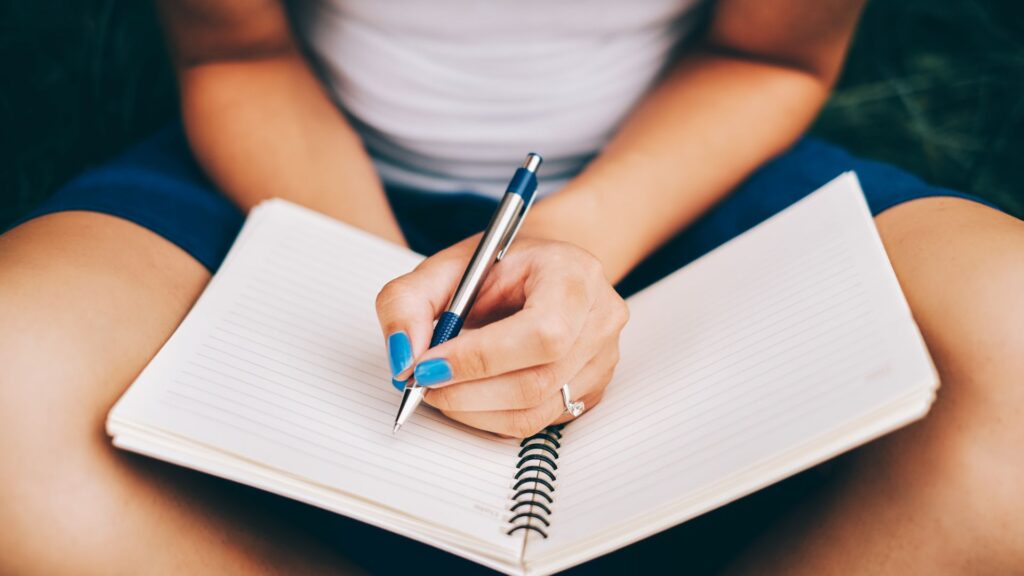 a girl writing a journal