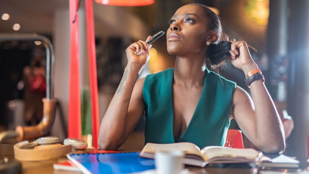 Black women thinking while writing. | How to retain what you read