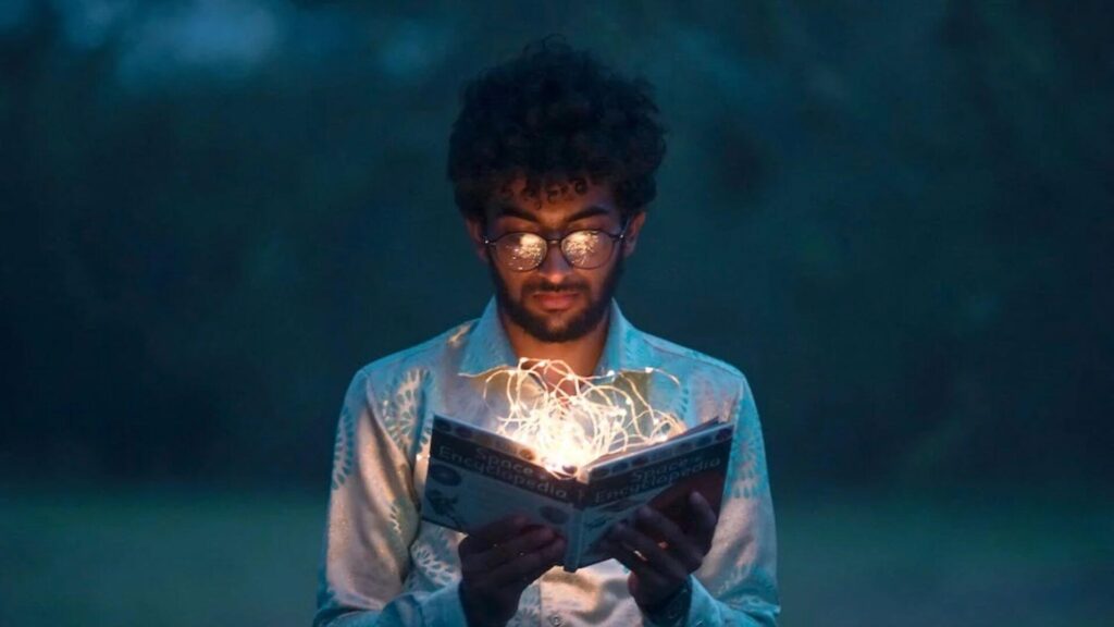 Boy holding book of light. | Ways to Stay Awake while Reading