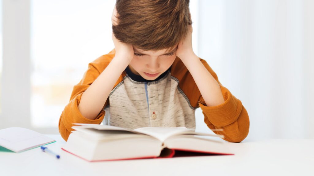 a kid reading without expression