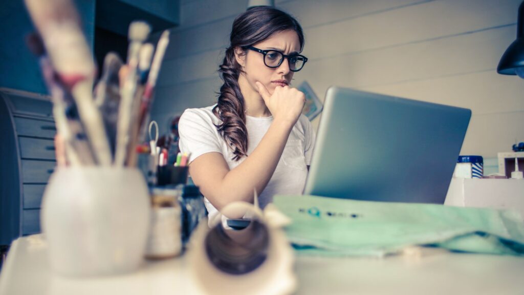 A women in glasses is concentrating on work.