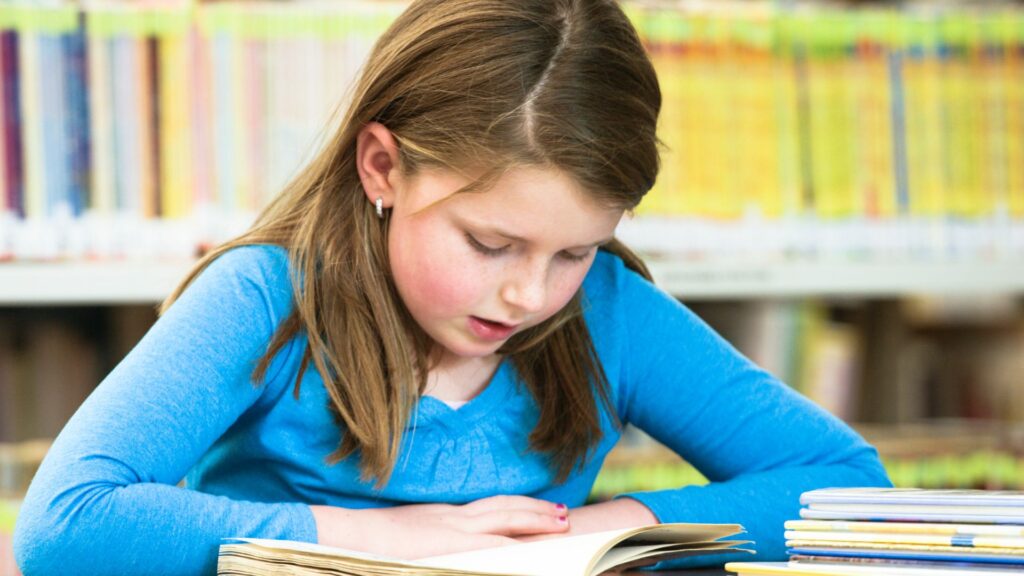 A girl reading book | How reading out loud helps with Stuttering